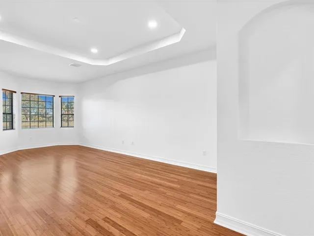 a bathroom with a tub a sink and a window