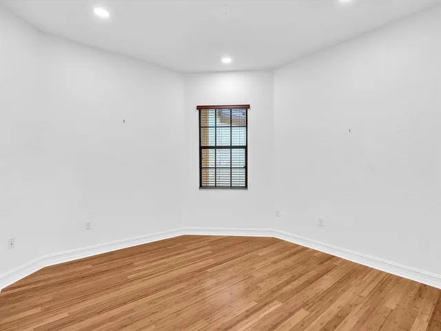 a front view of a house with a yard and potted plants
