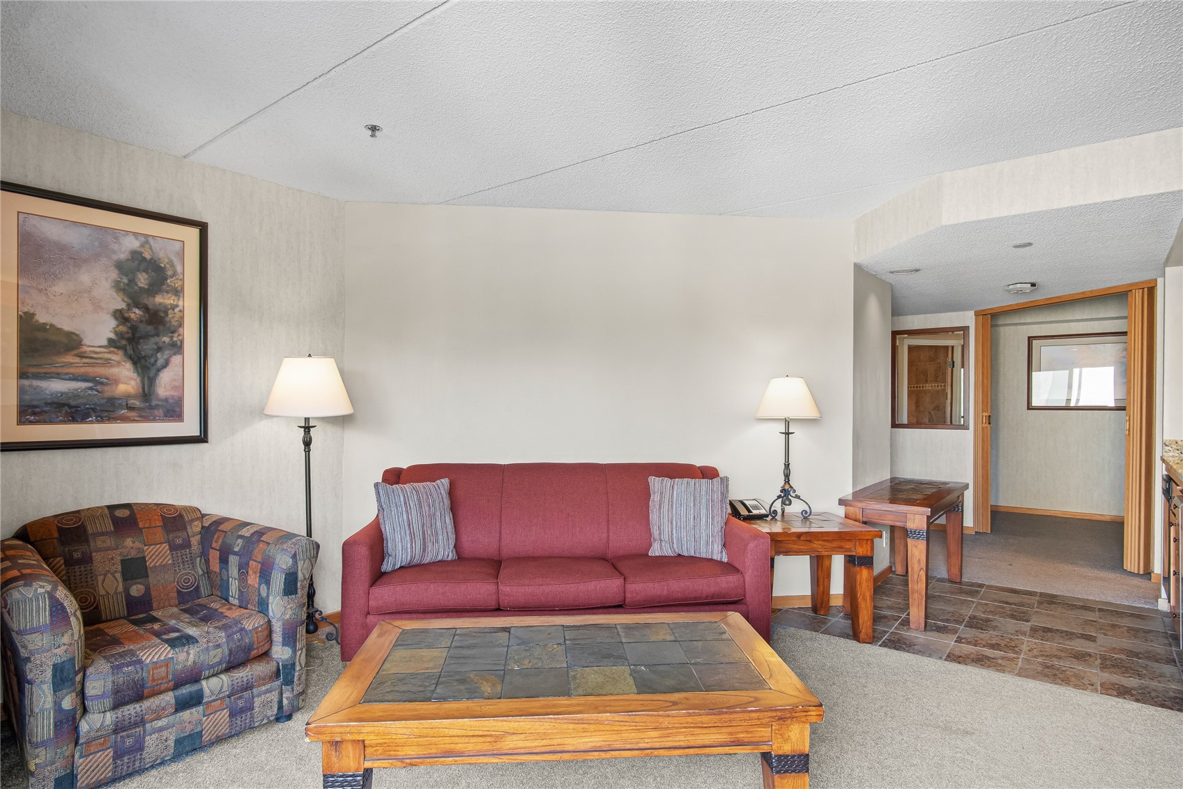 640 Village Road, Unit 4501 Breckenridge, CO 80424 - Photo 3 of 42 a living room with furniture and a lamp