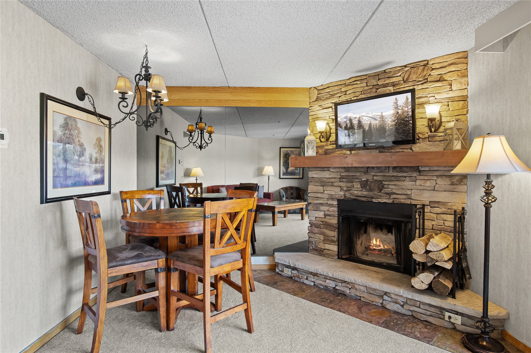 640 Village Road, Unit 4501 Breckenridge, CO 80424 - Photo 6 of 42 a dining room with furniture and a fireplace