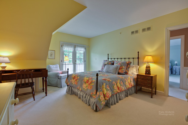 1390 Gettysburg Road Long Grove, IL 60047 - Photo 16 of 25 a spacious bedroom with a bed and a table in it