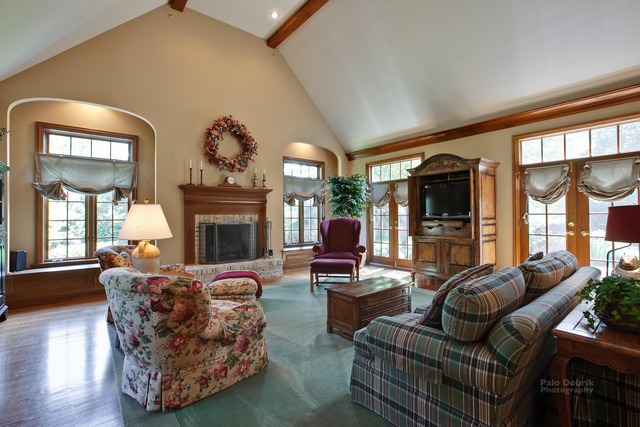 1390 Gettysburg Road Long Grove, IL 60047 - Photo 6 of 25 a living room with furniture a fireplace and a large window