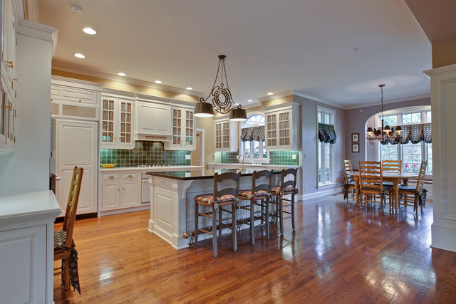 1390 Gettysburg Road Long Grove, IL 60047 - Photo 8 of 25 a kitchen with center island wooden floor stainless steel appliances and dining table