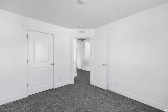 291 North Slant Road, Unit 46M Mapleton, UT 84660 - Photo 11 of 19 Unfurnished bedroom featuring dark carpet and a textured ceiling