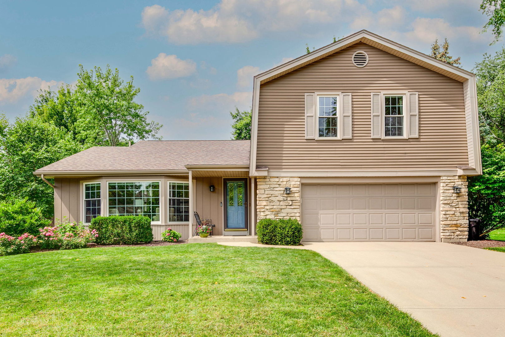 a front view of a house with a yard and garage