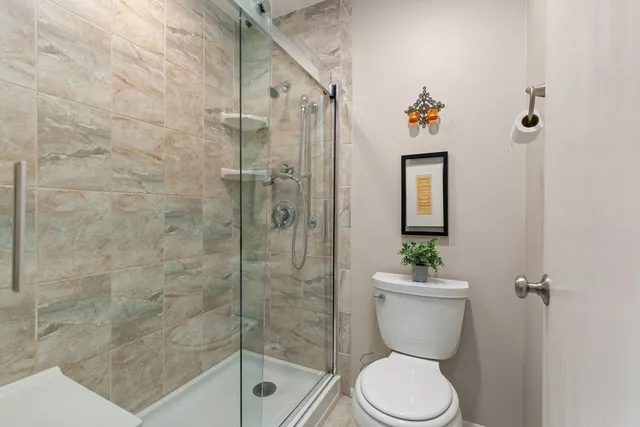 a bathroom with a toilet and a shower