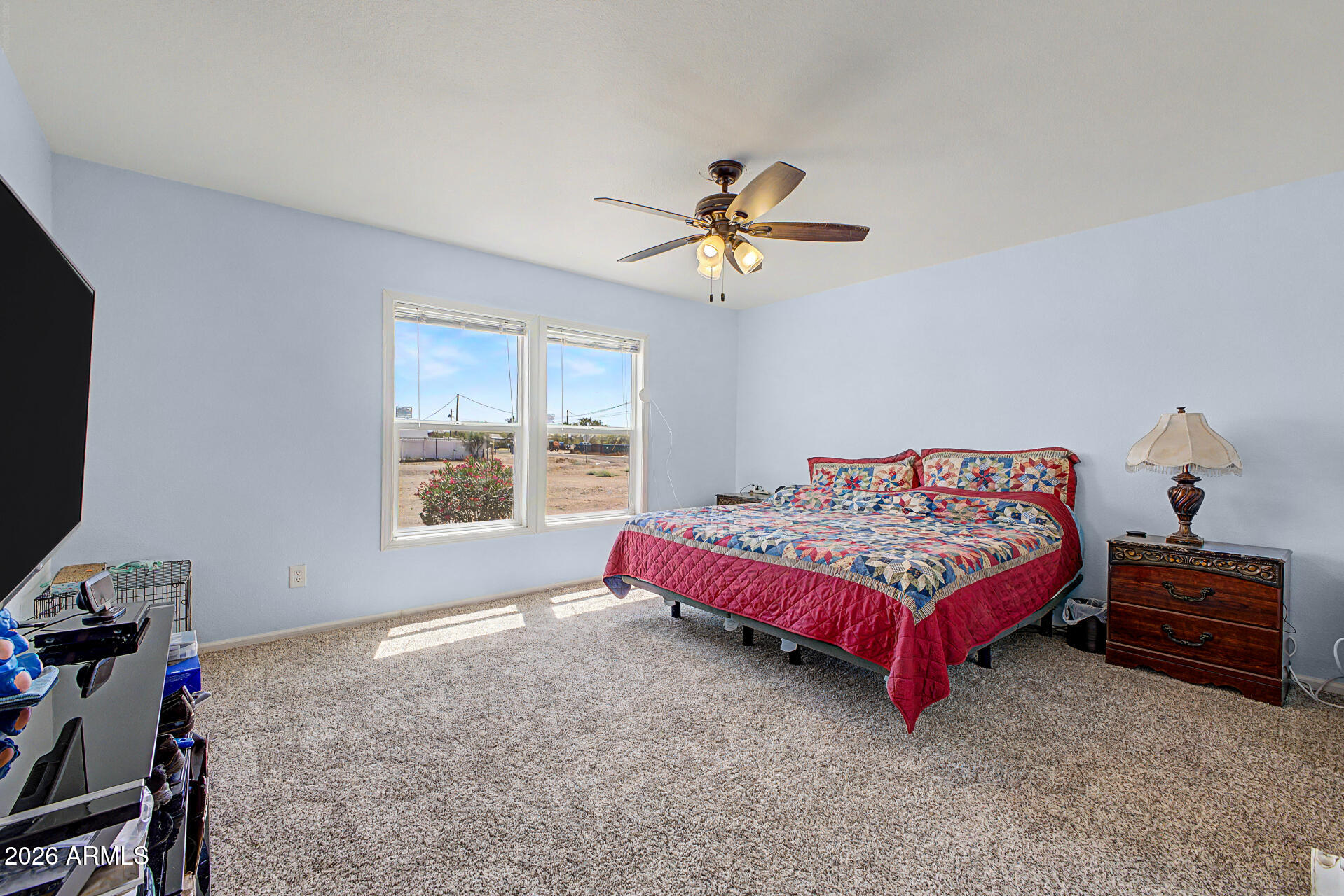 2576 West Tepee Street Apache Junction, AZ 85120 - Photo 12 of 29 a spacious bedroom with a bed and a window