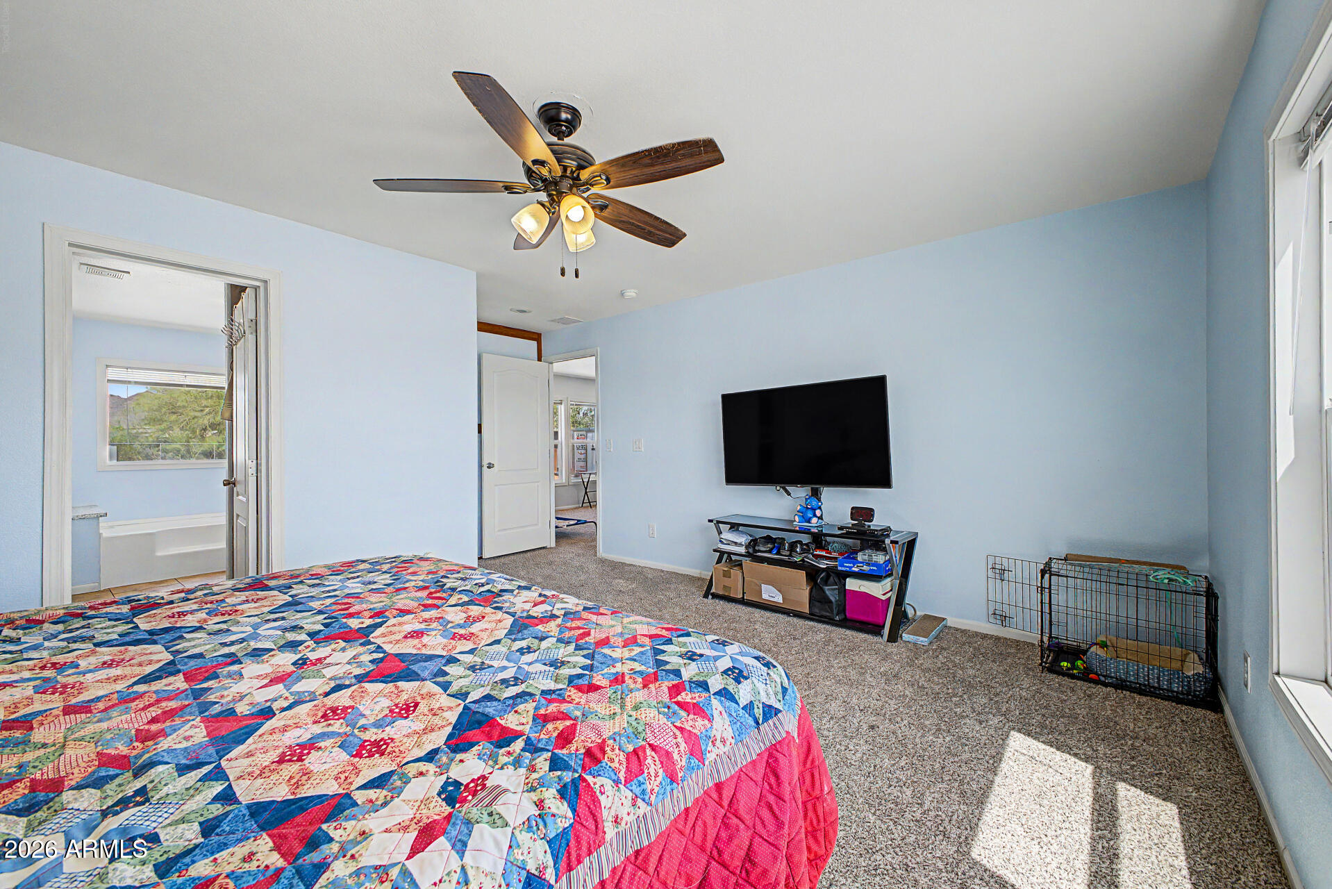 2576 West Tepee Street Apache Junction, AZ 85120 - Photo 13 of 29 a bedroom with a bed and a flat screen tv