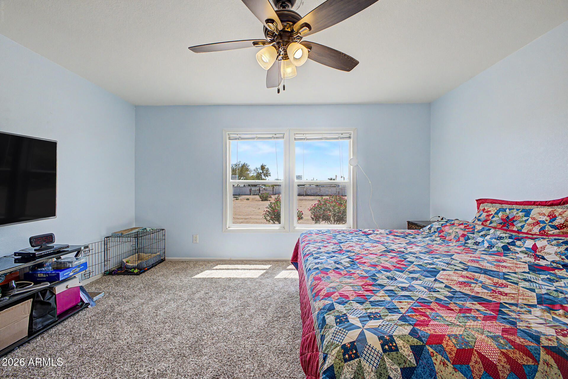 2576 West Tepee Street Apache Junction, AZ 85120 - Photo 14 of 29 a bedroom with a bed and a chandelier