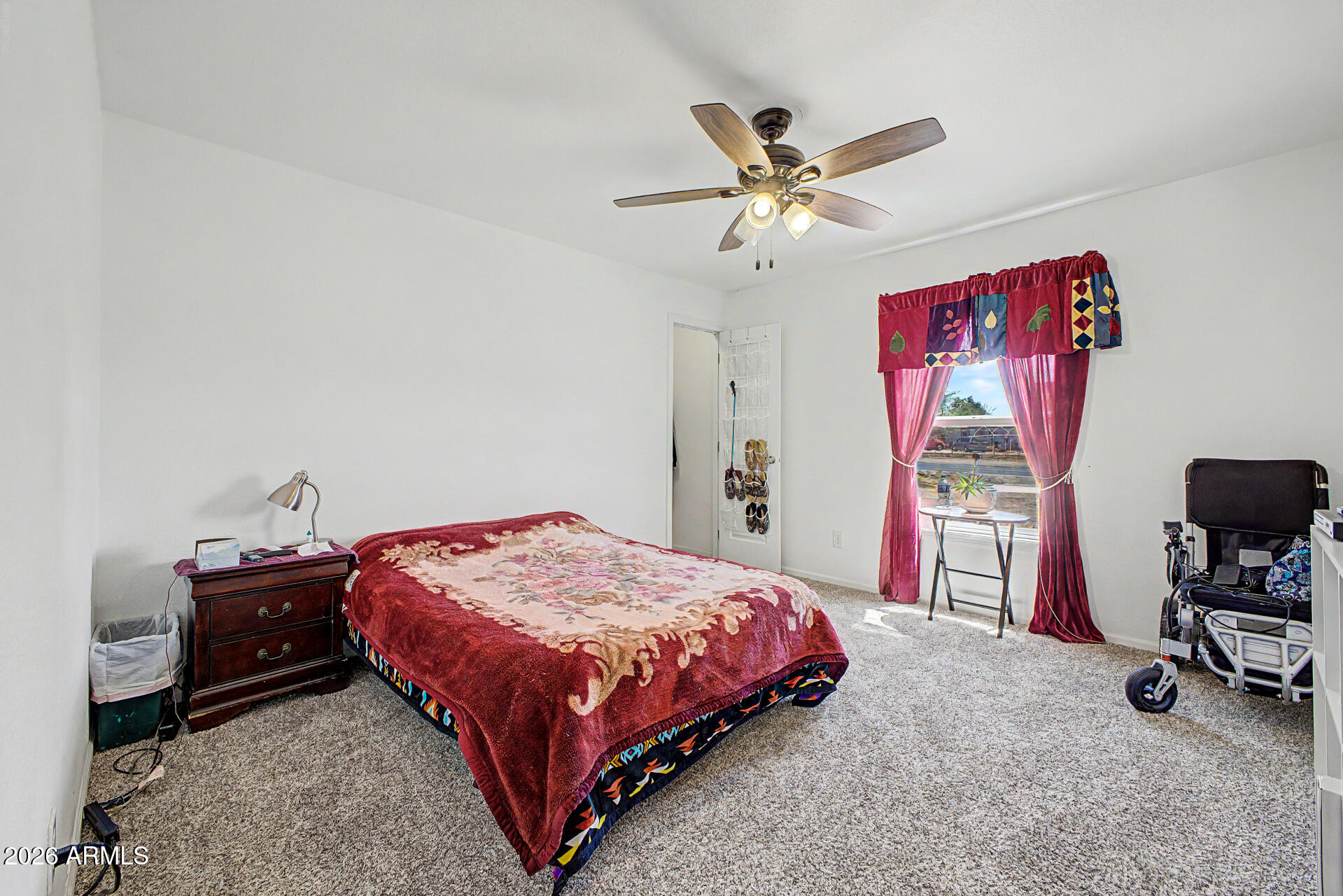 2576 West Tepee Street Apache Junction, AZ 85120 - Photo 17 of 29 a bedroom with a bed and a chandelier