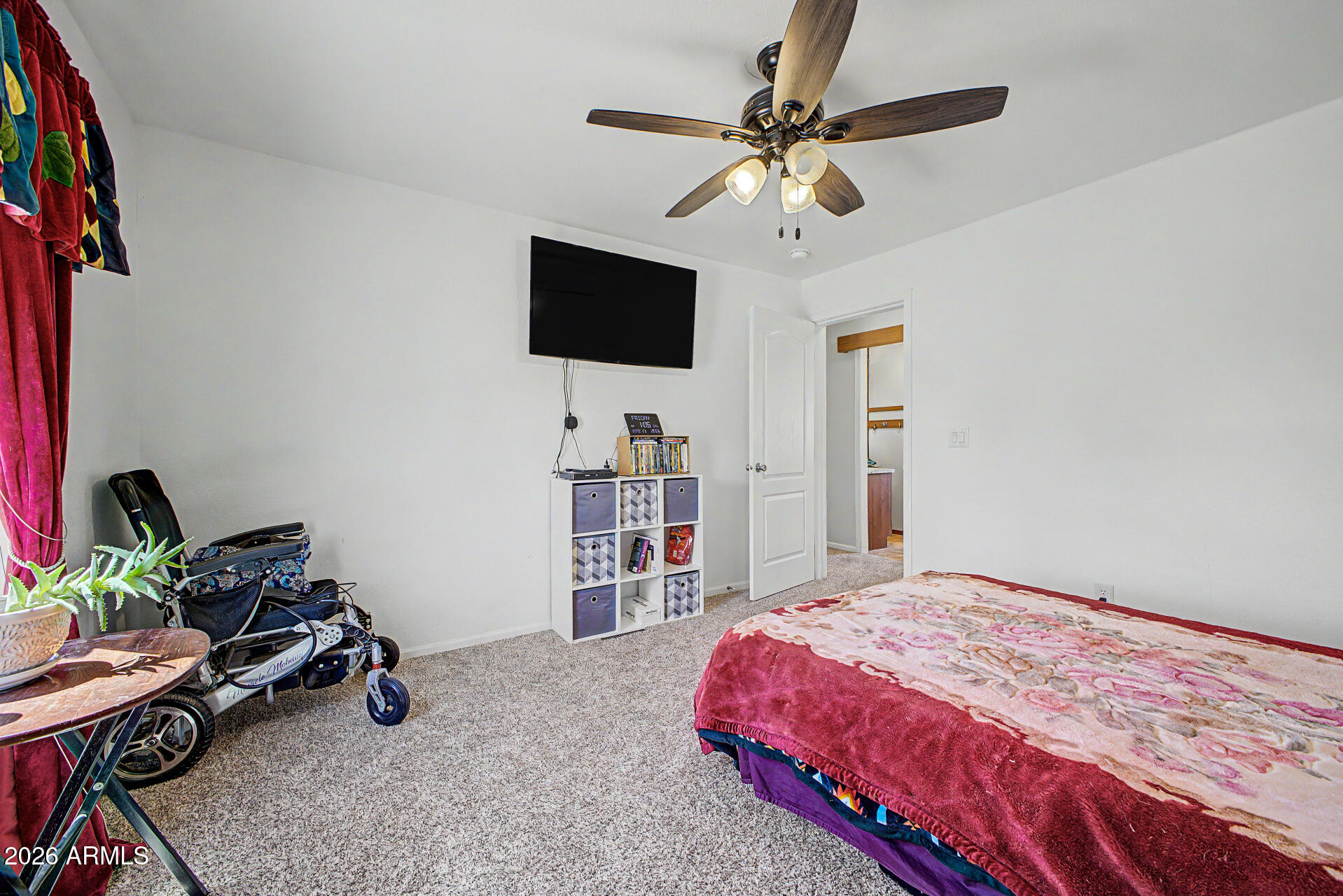 2576 West Tepee Street Apache Junction, AZ 85120 - Photo 18 of 29 a bedroom with a bed and a flat screen tv