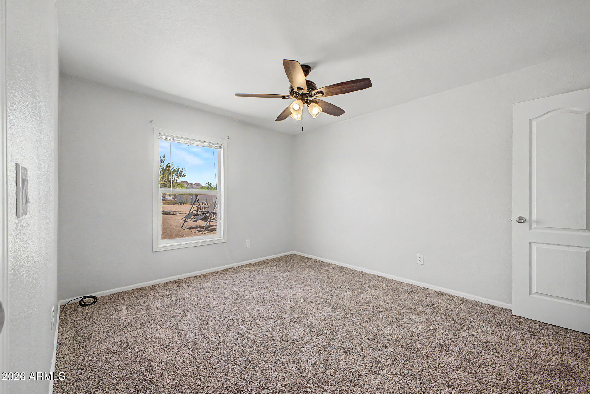 2576 West Tepee Street Apache Junction, AZ 85120 - Photo 21 of 29 an empty room with windows and fan