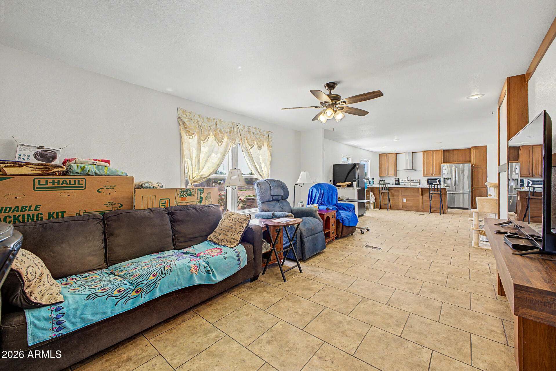 2576 West Tepee Street Apache Junction, AZ 85120 - Photo 5 of 29 a living room with furniture kitchen view and a chandelier