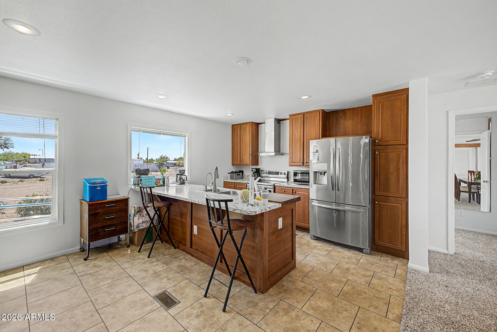 2576 West Tepee Street Apache Junction, AZ 85120 - Photo 8 of 29 a room with kitchen island a center island a counter top space and stainless steel appliances