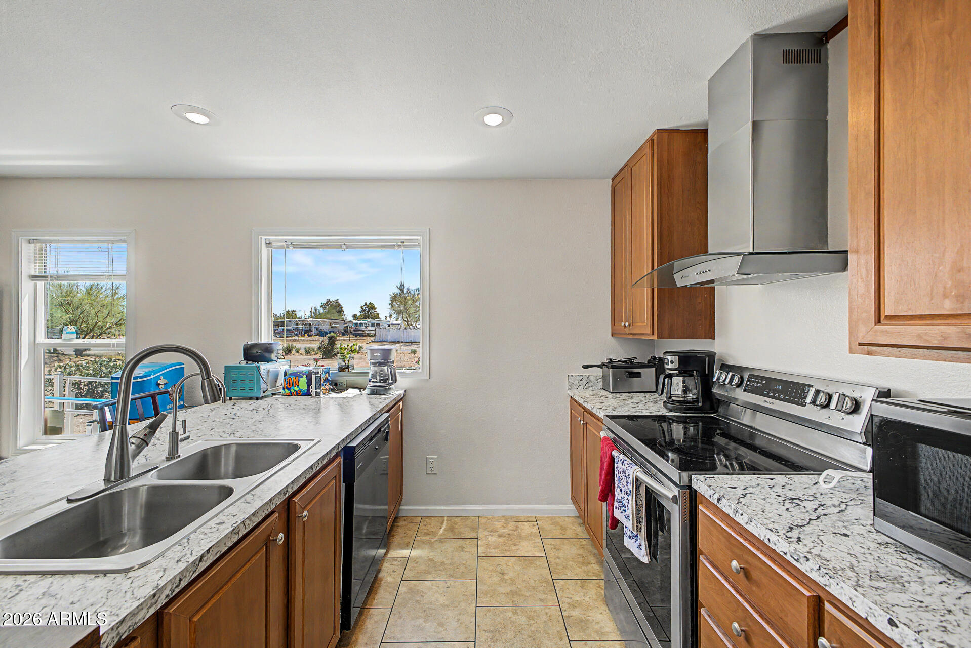 2576 West Tepee Street Apache Junction, AZ 85120 - Photo 10 of 29 a kitchen with stainless steel appliances granite countertop a sink stove and refrigerator