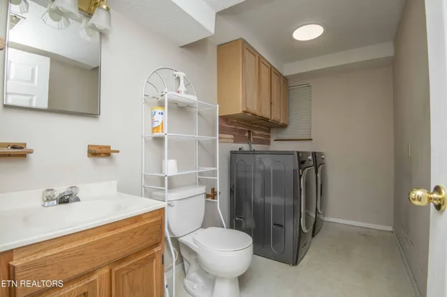 a bathroom with a toilet a sink and a shower