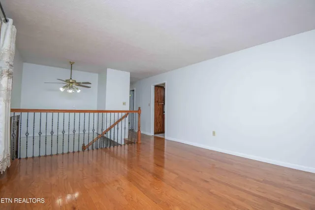 a view of a room with wooden floor
