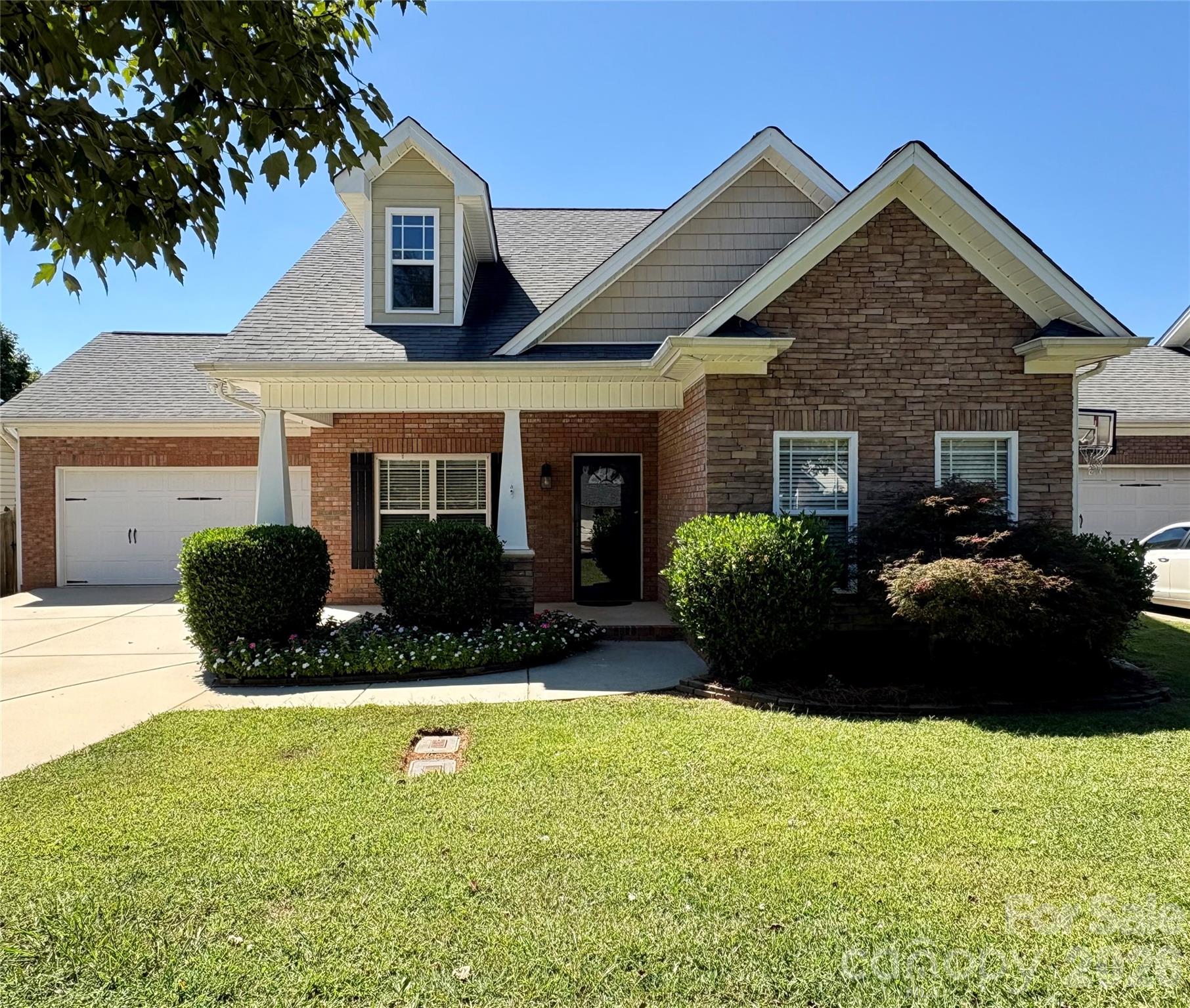 a front view of a house with a garden