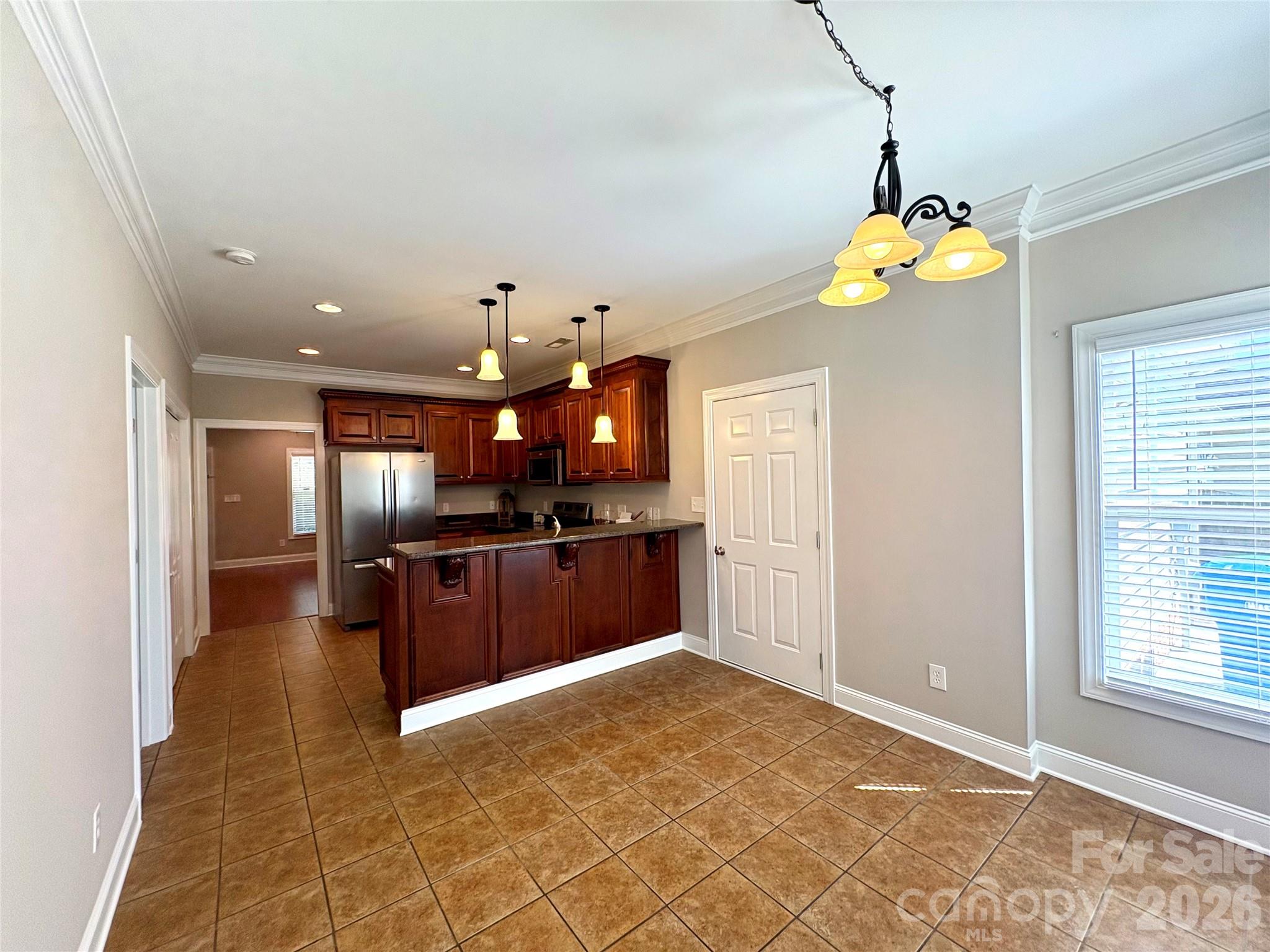 402 Church Street Locust, NC 28097 - Photo 11 of 39 a view of a kitchen with a sink and chandelier