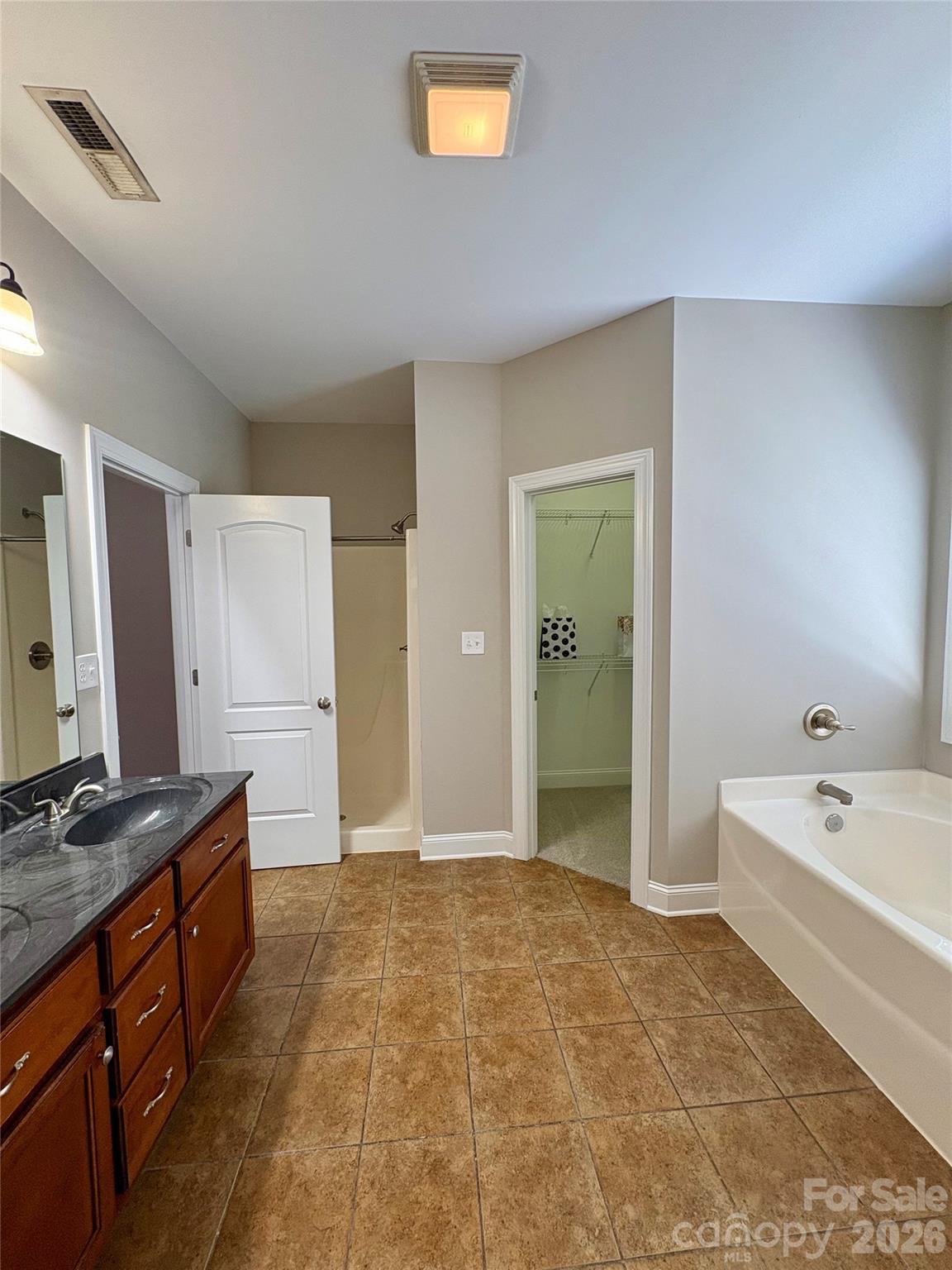 402 Church Street Locust, NC 28097 - Photo 15 of 39 a spacious bathroom with a tub sink and mirror