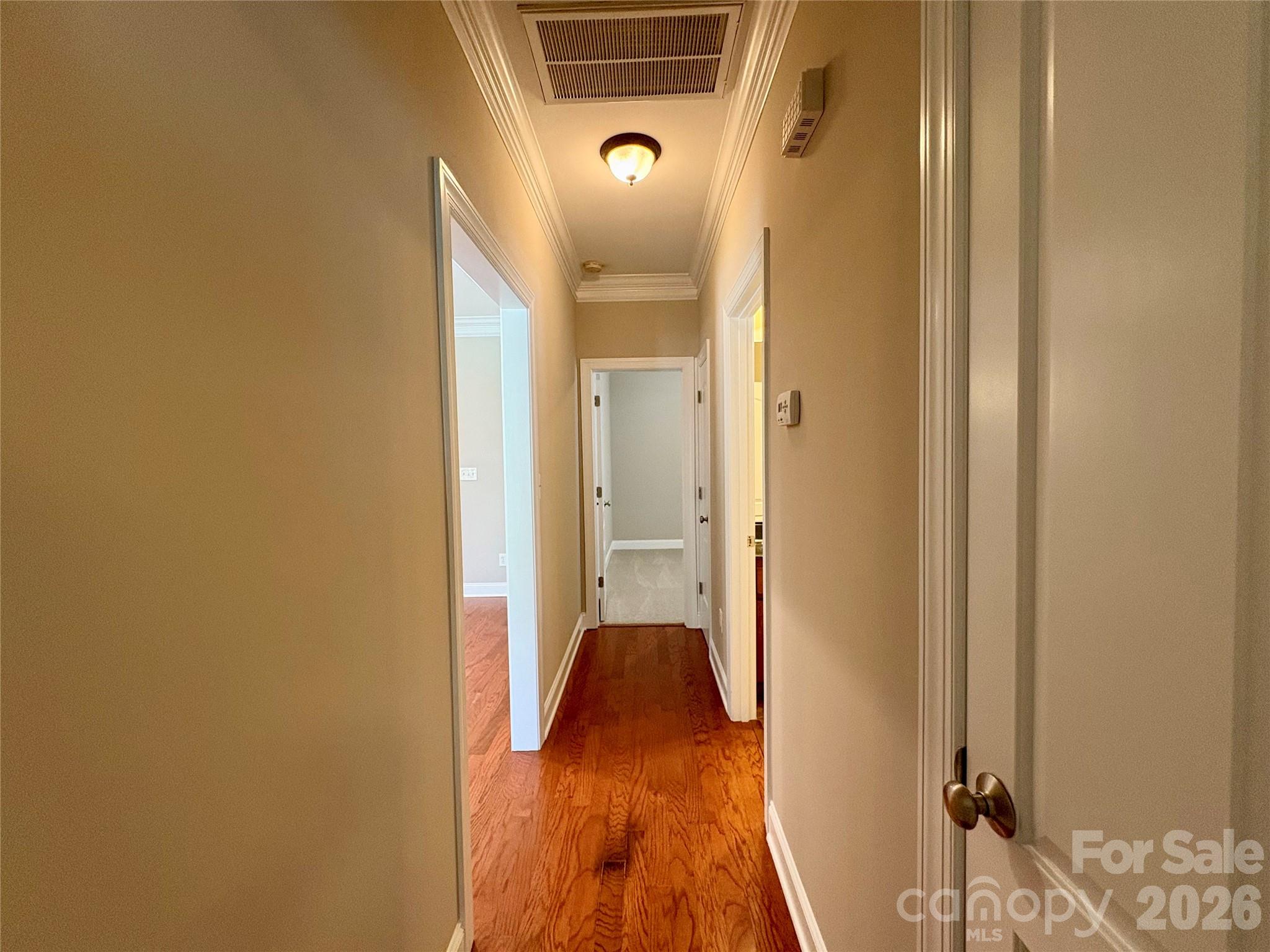 402 Church Street Locust, NC 28097 - Photo 18 of 39 a view of a hallway with wooden floor and a bathroom
