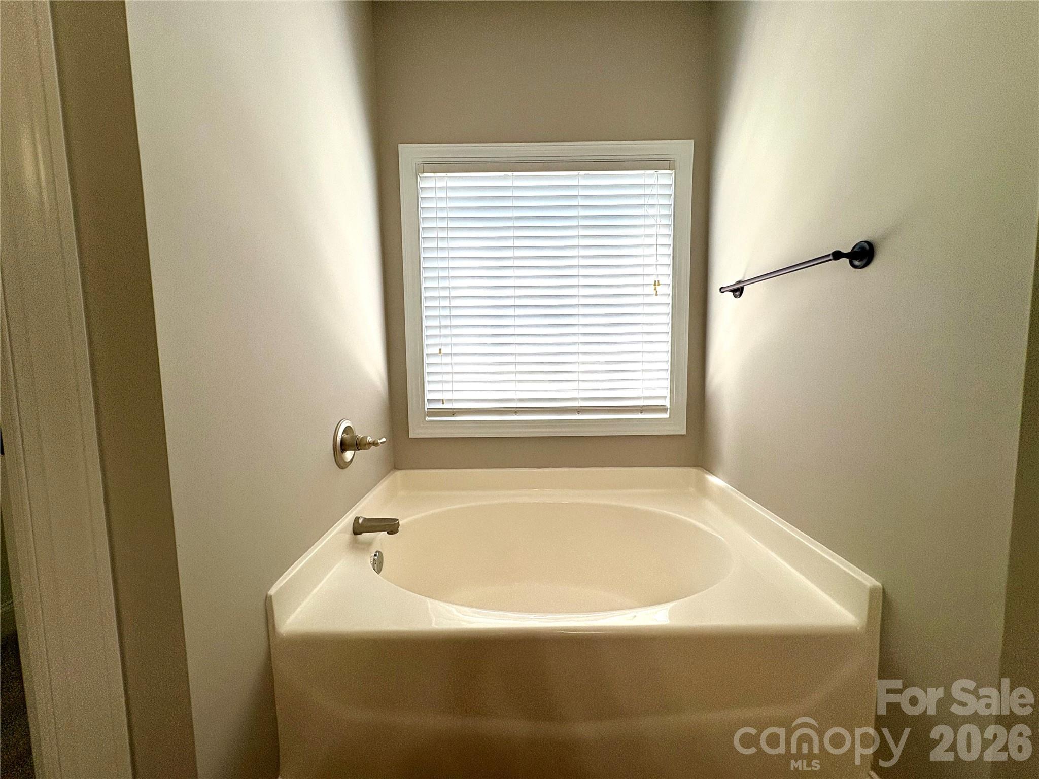 402 Church Street Locust, NC 28097 - Photo 19 of 39 a white bath tub sitting in a bathroom next to a window