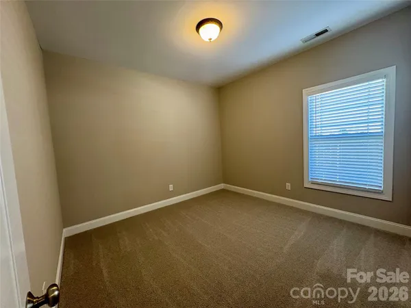 an empty room with a empty space and a window