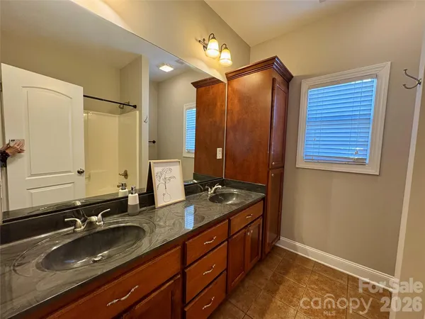 a bathroom with a double vanity sink and a mirror
