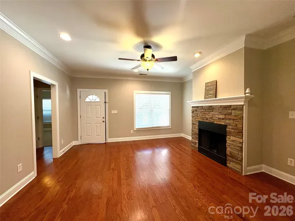 a view of an empty room with a fireplace and a window