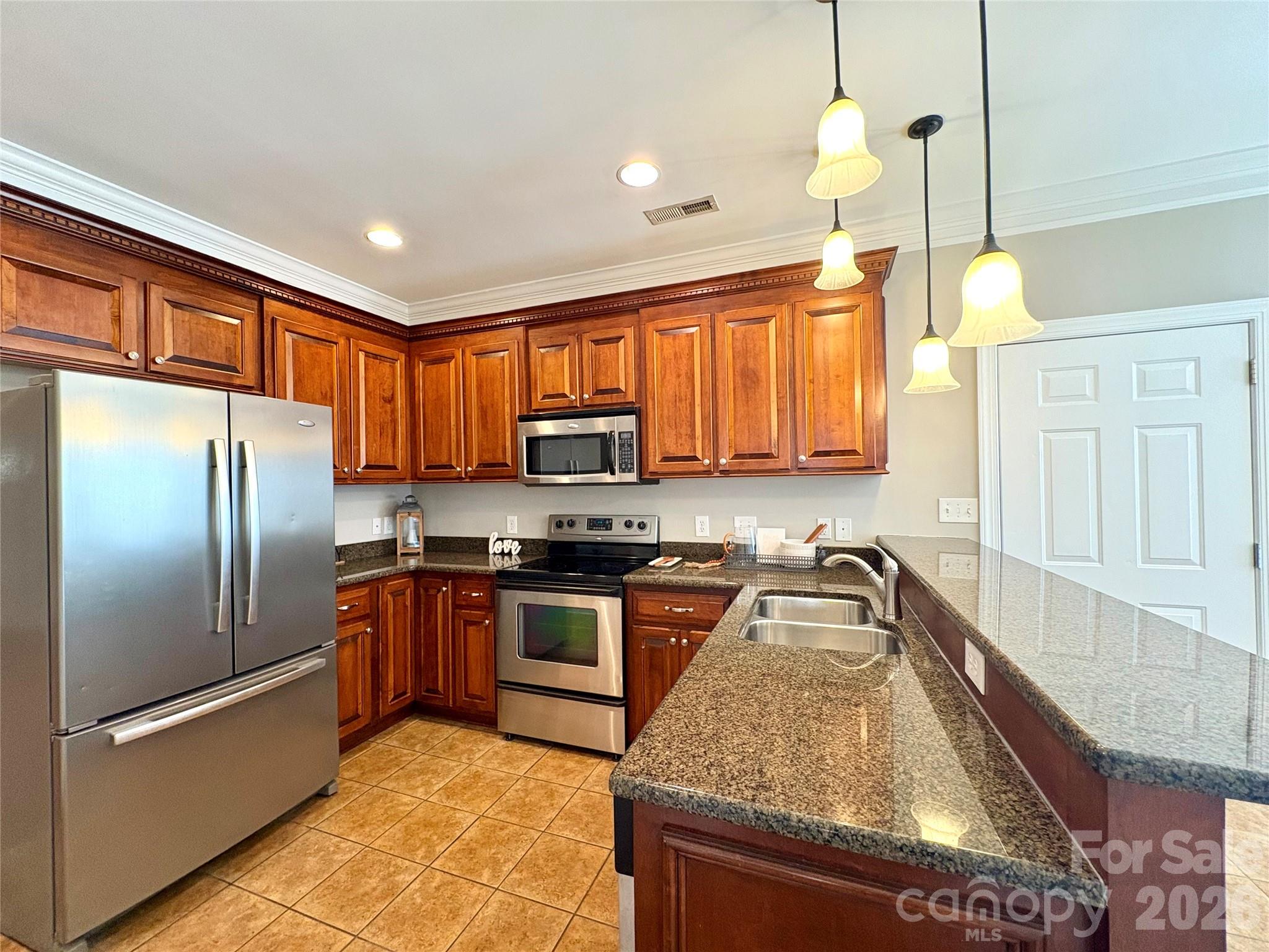 402 Church Street Locust, NC 28097 - Photo 9 of 39 a kitchen with stainless steel appliances granite countertop a sink a stove and a refrigerator