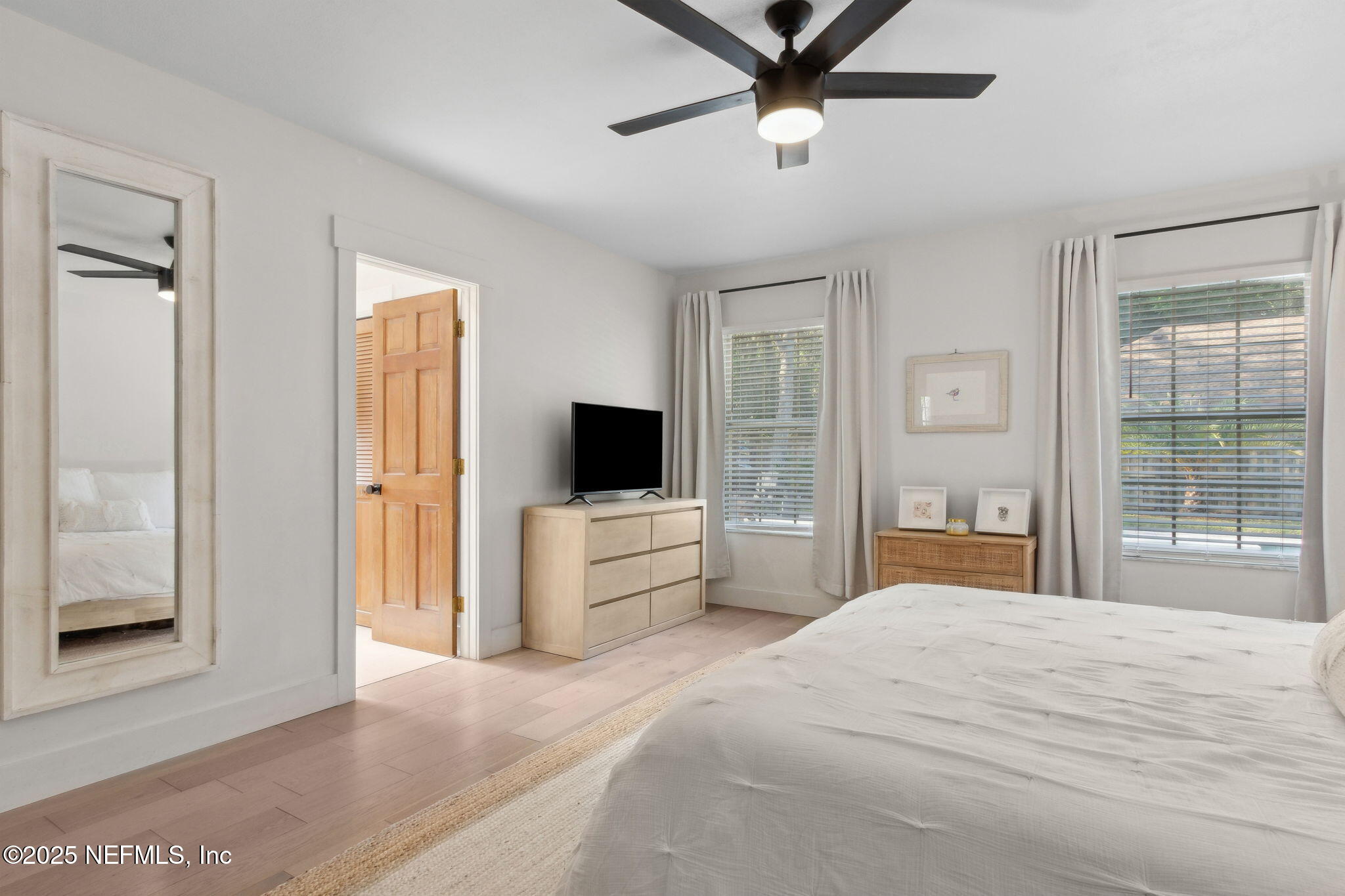 1908 Springbrook Road Fernandina Beach, FL 32034 - Photo 26 of 48 a bedroom with a large bed and a flat screen tv