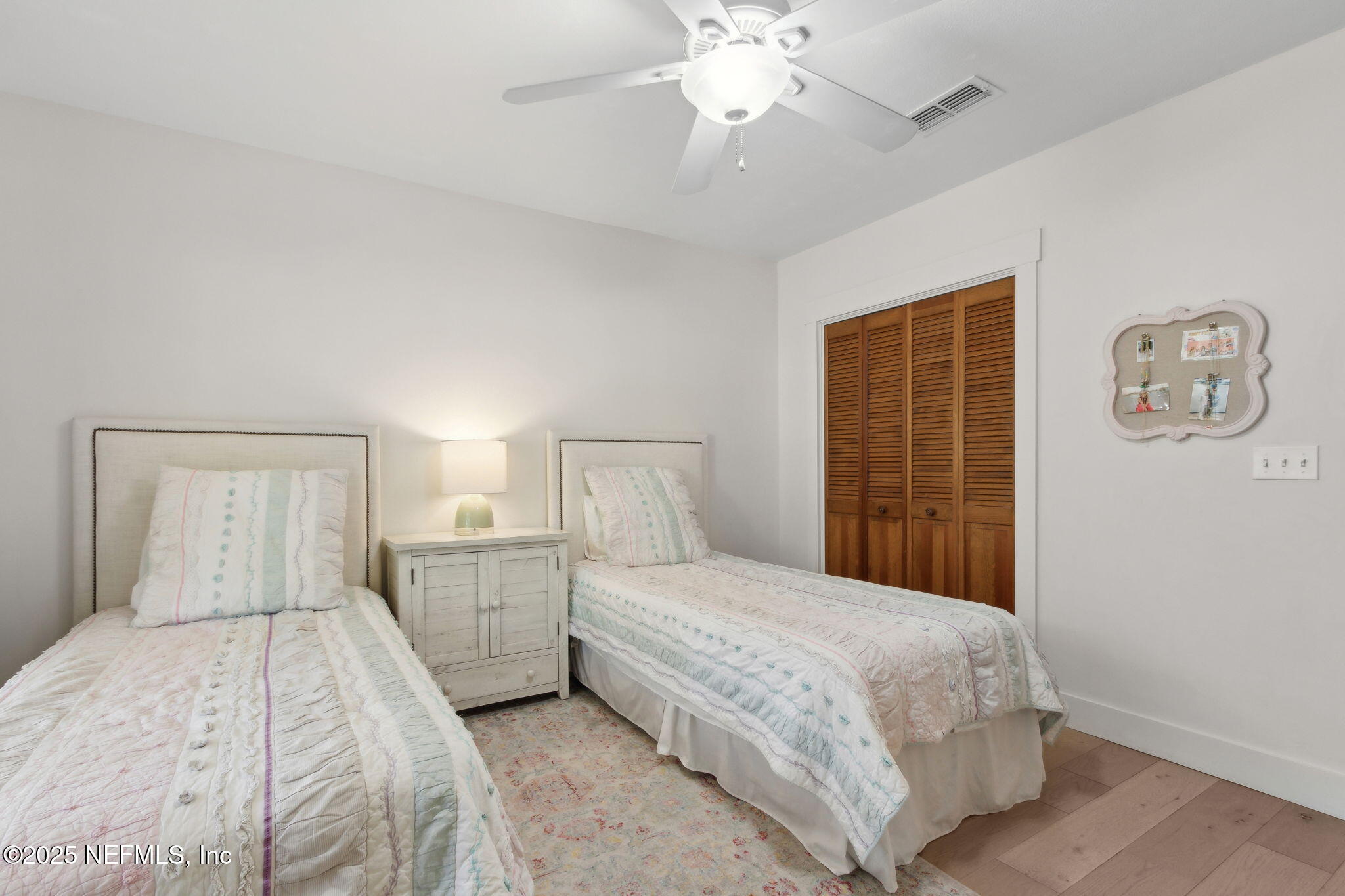1908 Springbrook Road Fernandina Beach, FL 32034 - Photo 31 of 48 a bedroom with a large bed and a chandelier