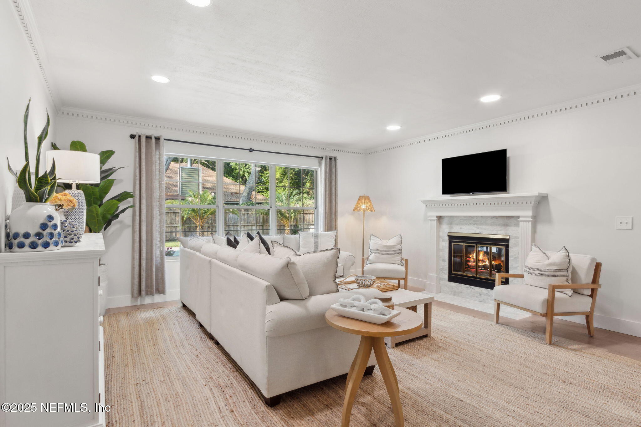 1908 Springbrook Road Fernandina Beach, FL 32034 - Photo 5 of 48 a living room with furniture a fireplace and a flat screen tv