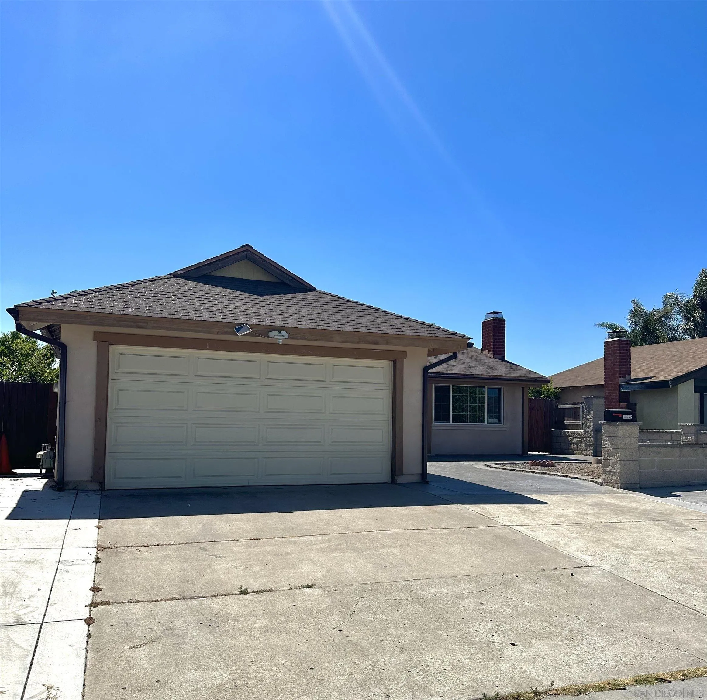 10762 Fenwick Road San Diego, CA 92126 - Photo 1 of 10 a front view of a house with a yard and garage