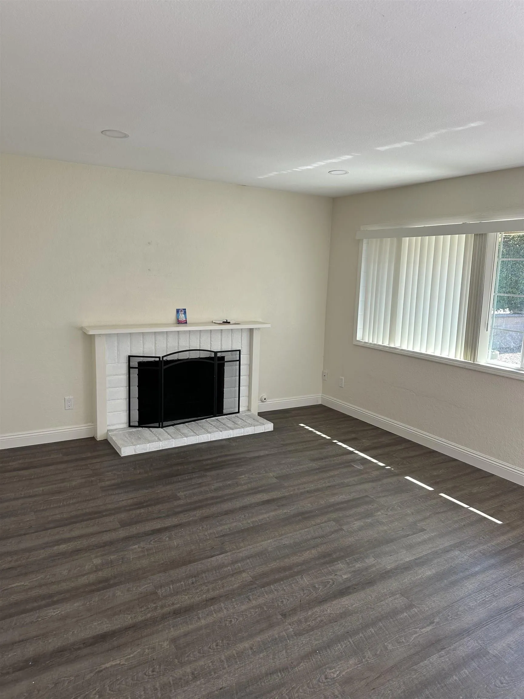 10762 Fenwick Road San Diego, CA 92126 - Photo 2 of 10 a view of empty room with wooden floor and fireplace
