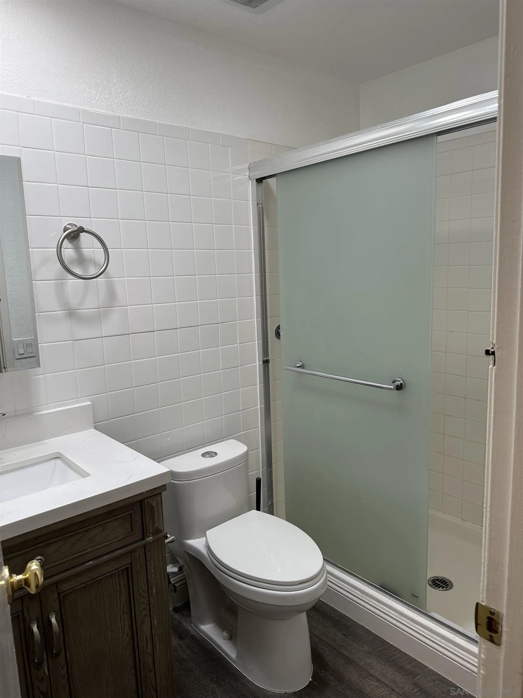 10762 Fenwick Road San Diego, CA 92126 - Photo 8 of 10 a bathroom with a toilet a sink and shower