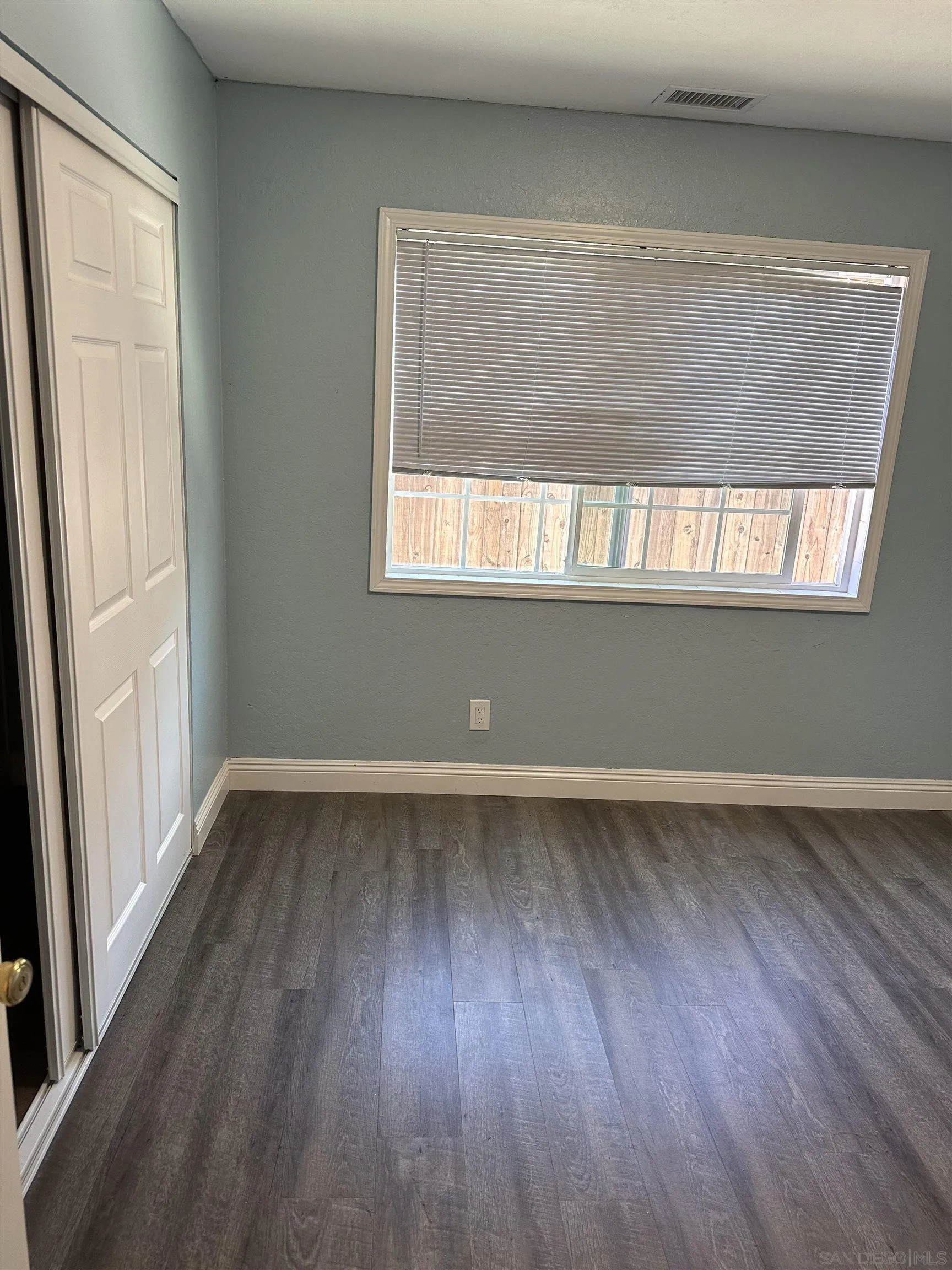 10762 Fenwick Road San Diego, CA 92126 - Photo 9 of 10 an empty room with wooden floor and windows