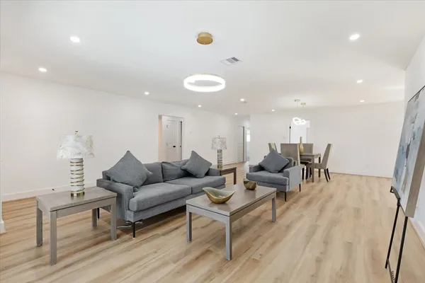 a view of a dining room with furniture and wooden floor