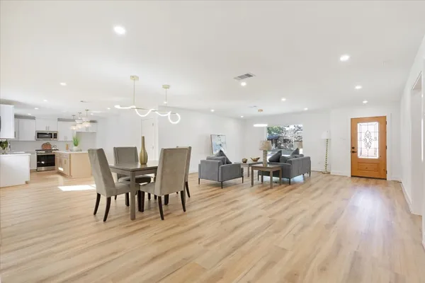 a kitchen with kitchen island a sink stainless steel appliances and cabinets