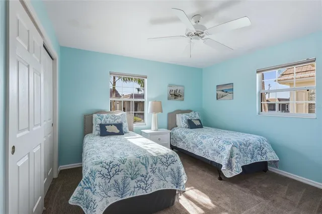 a bedroom with two beds and a chandelier