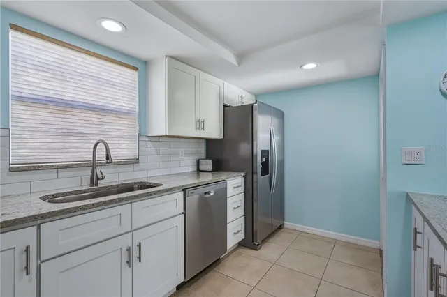 a kitchen with a sink cabinets and appliances
