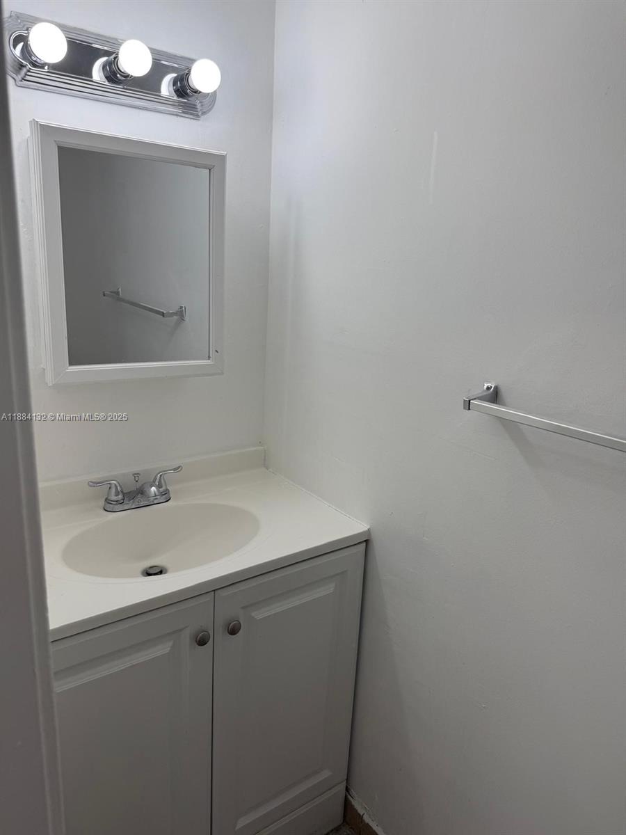 1255 West 53rd Street, Unit 202 Hialeah, FL 33012 - Photo 4 of 11 a bathroom with a sink and mirror