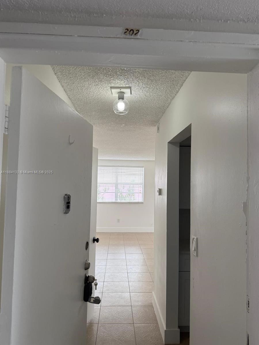 1255 West 53rd Street, Unit 202 Hialeah, FL 33012 - Photo 10 of 11 a view of a hallway