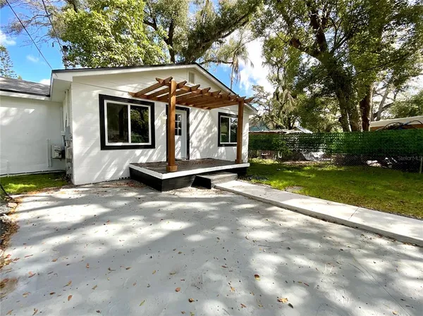 a view of a small house with backyard