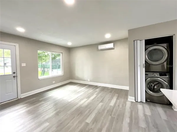 a living room with furniture a window and a potted plant