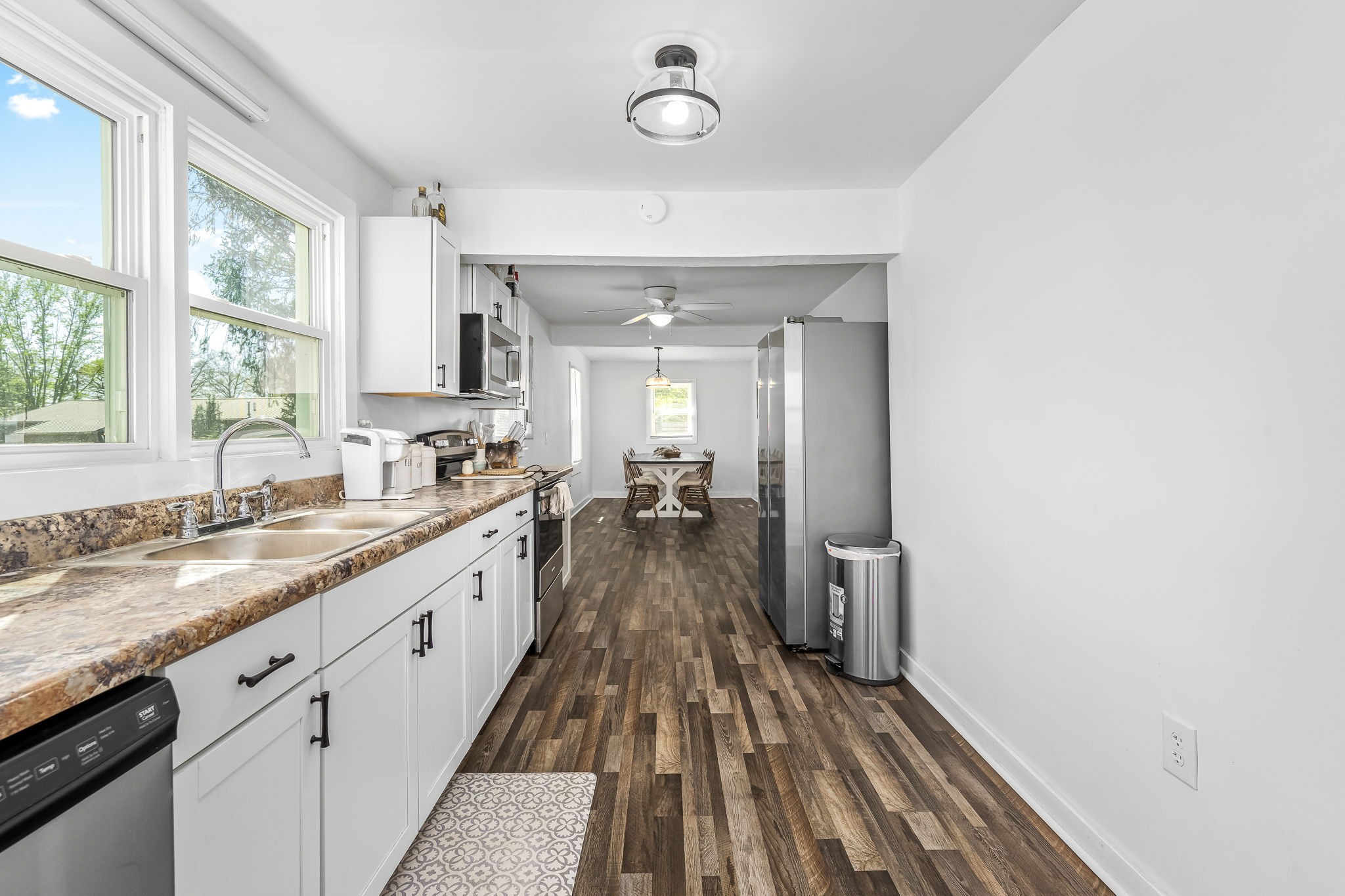 620 Maple Bend Road Winchester, TN 37398 - Photo 21 of 68 a view of a kitchen with a sink dishwasher wooden floor and a window