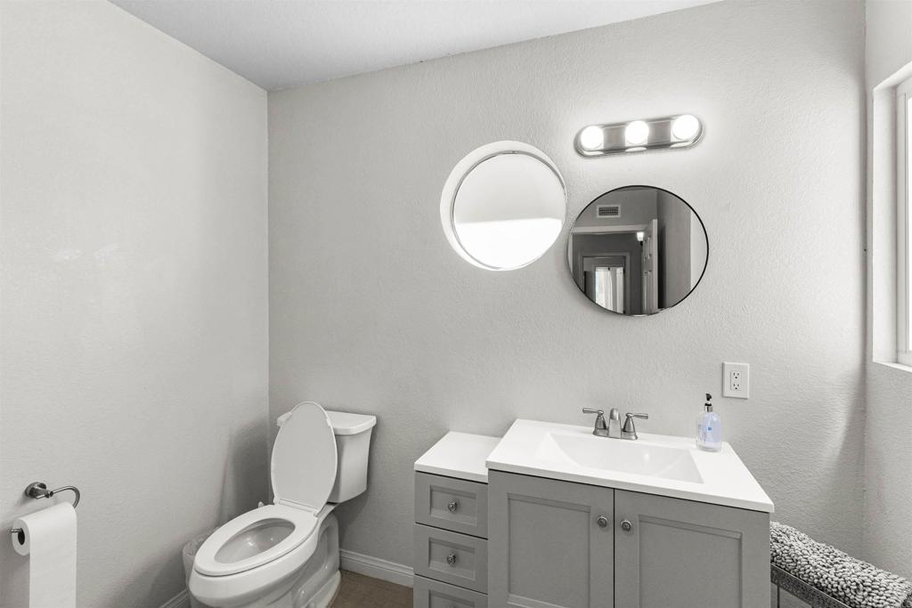 3340 Skytrail Ranch Road Jamul, CA 91935 - Photo 22 of 38 a bathroom with a toilet sink vanity and mirror