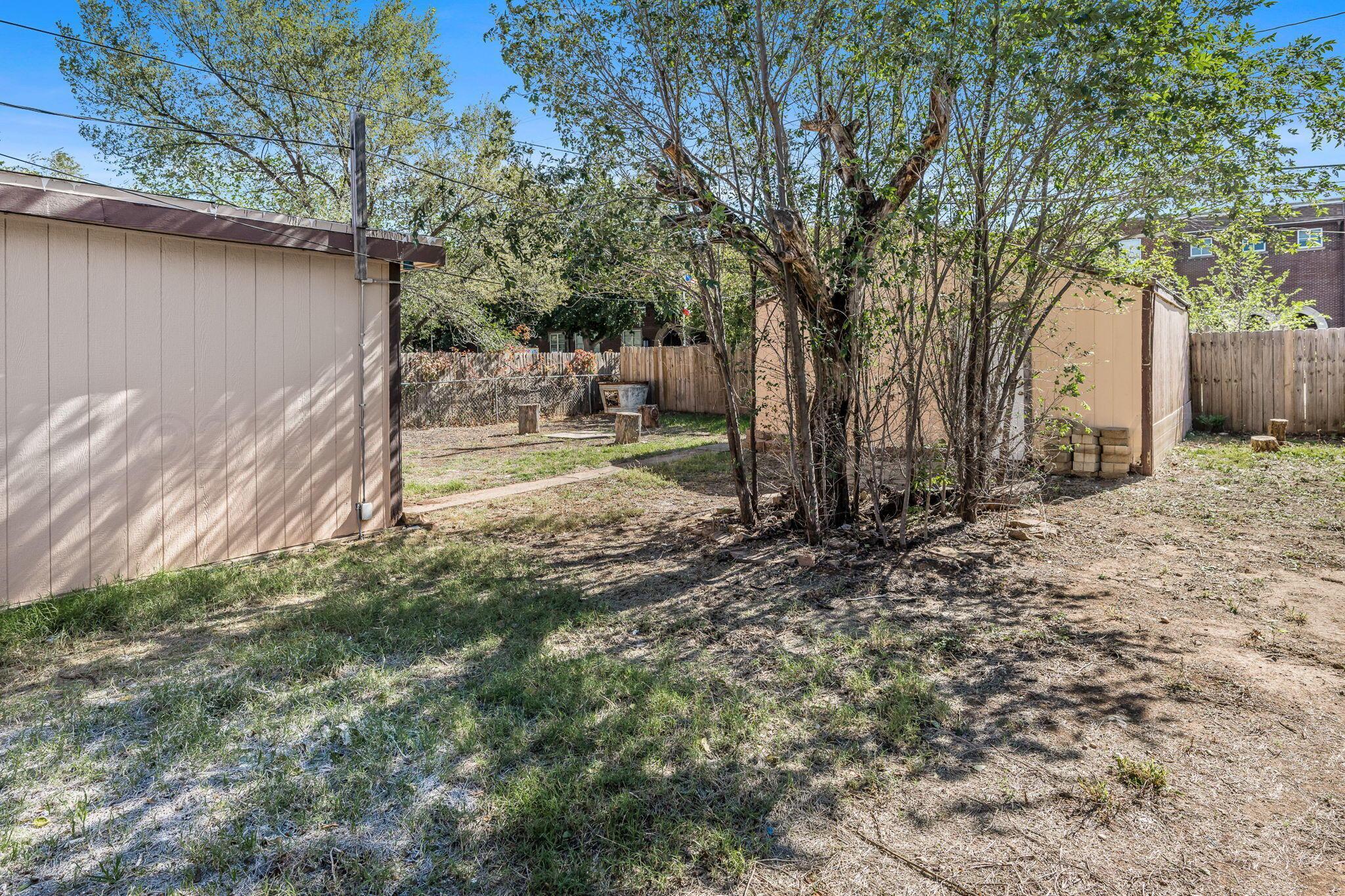 606 Sunset Terrace Amarillo, TX 79106 - Photo 16 of 16 a backyard of a house with barbeque oven table and chairs