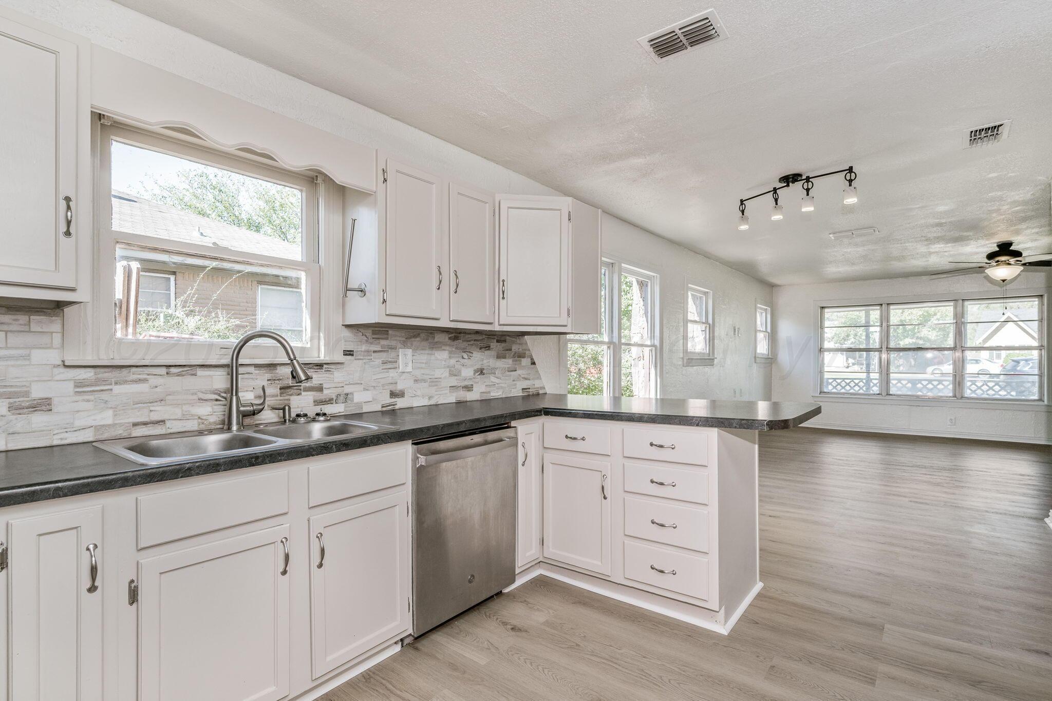606 Sunset Terrace Amarillo, TX 79106 - Photo 6 of 16 a kitchen with appliances cabinets and a large window