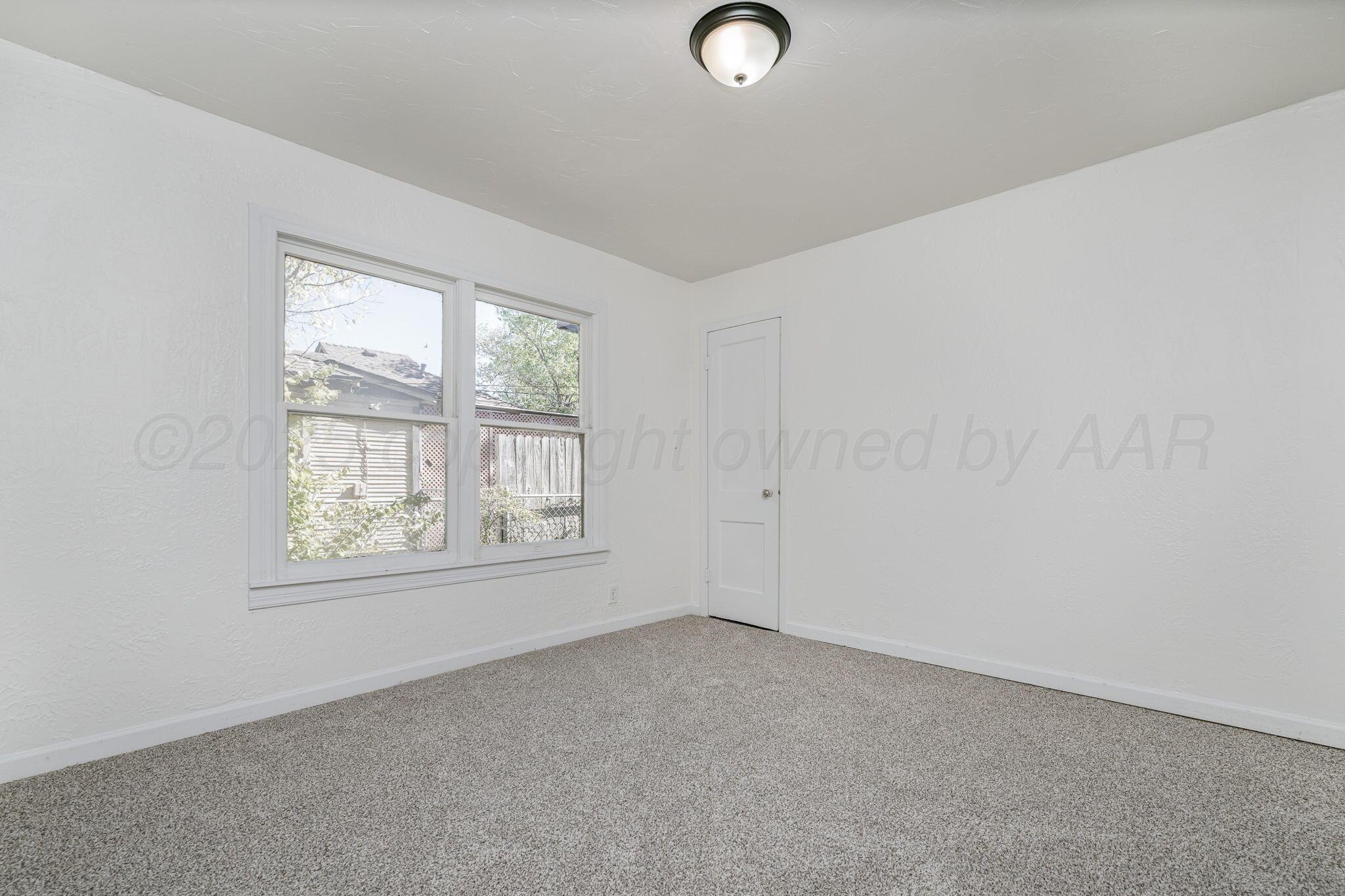 606 Sunset Terrace Amarillo, TX 79106 - Photo 10 of 16 an empty room with windows